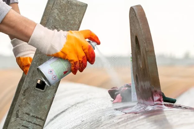 Dye Penetrant Testing DPT showing red penetrant indications on weld surface