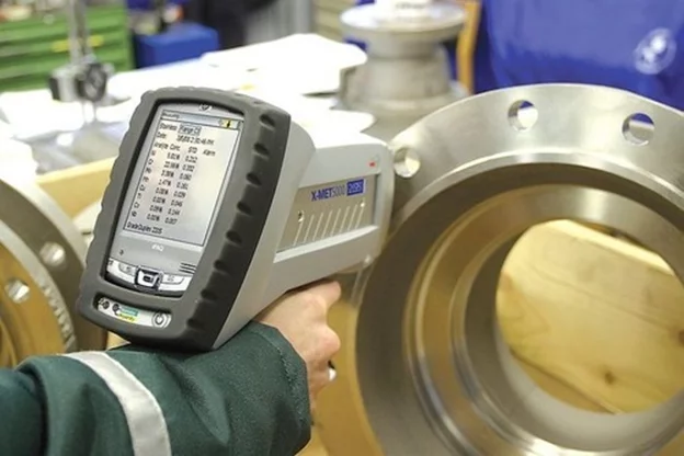 Positive Material Identification PMI XRF analyser being used on a pipe weld to verify alloy composition