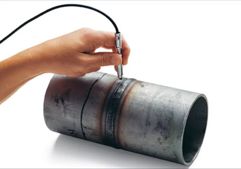 Ferrite testing using a ferritescope probe on a stainless steel weld specimen